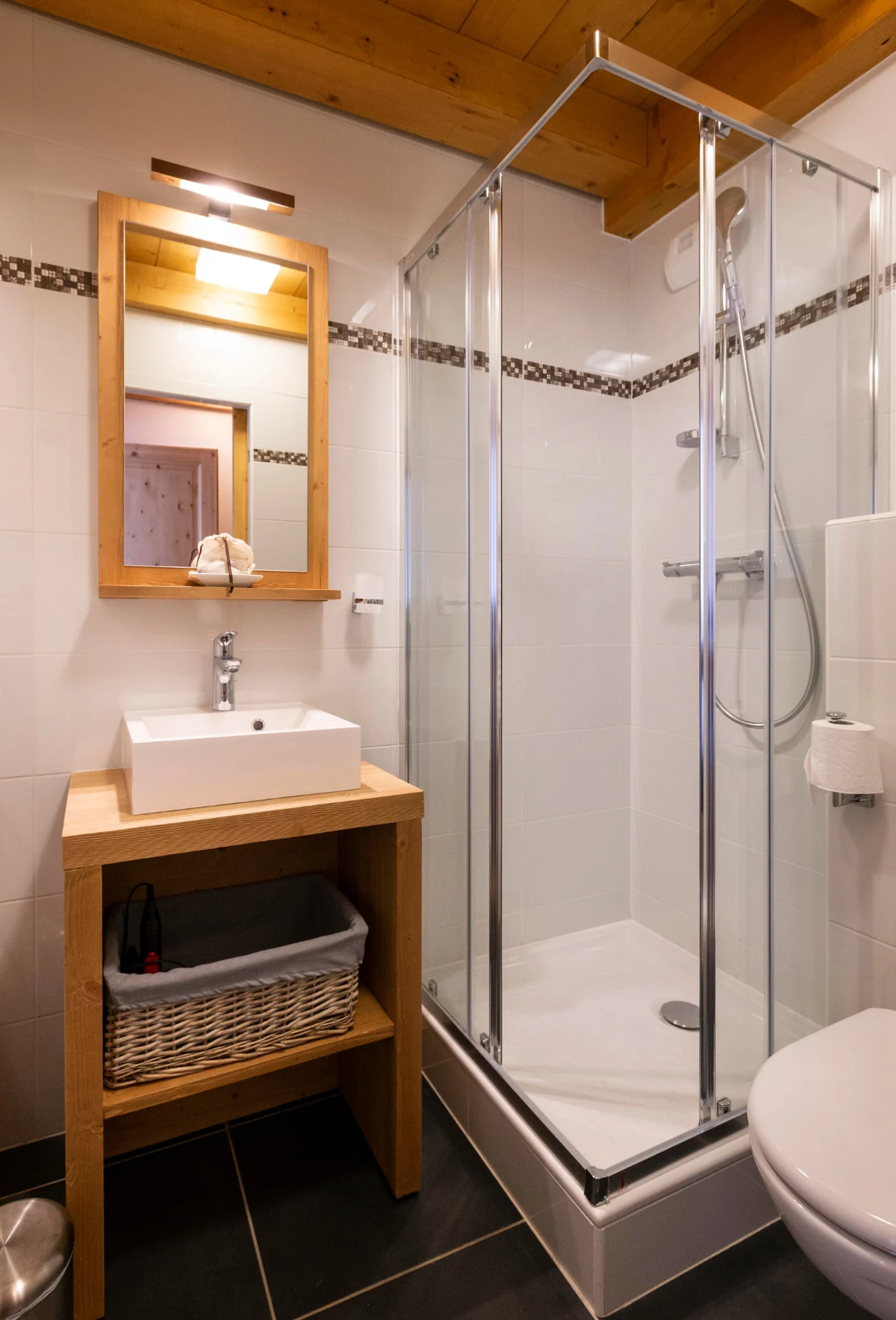 Salle de douche de l'appartement San Bernardo avec cabine vitrée, vasque et meuble en bois