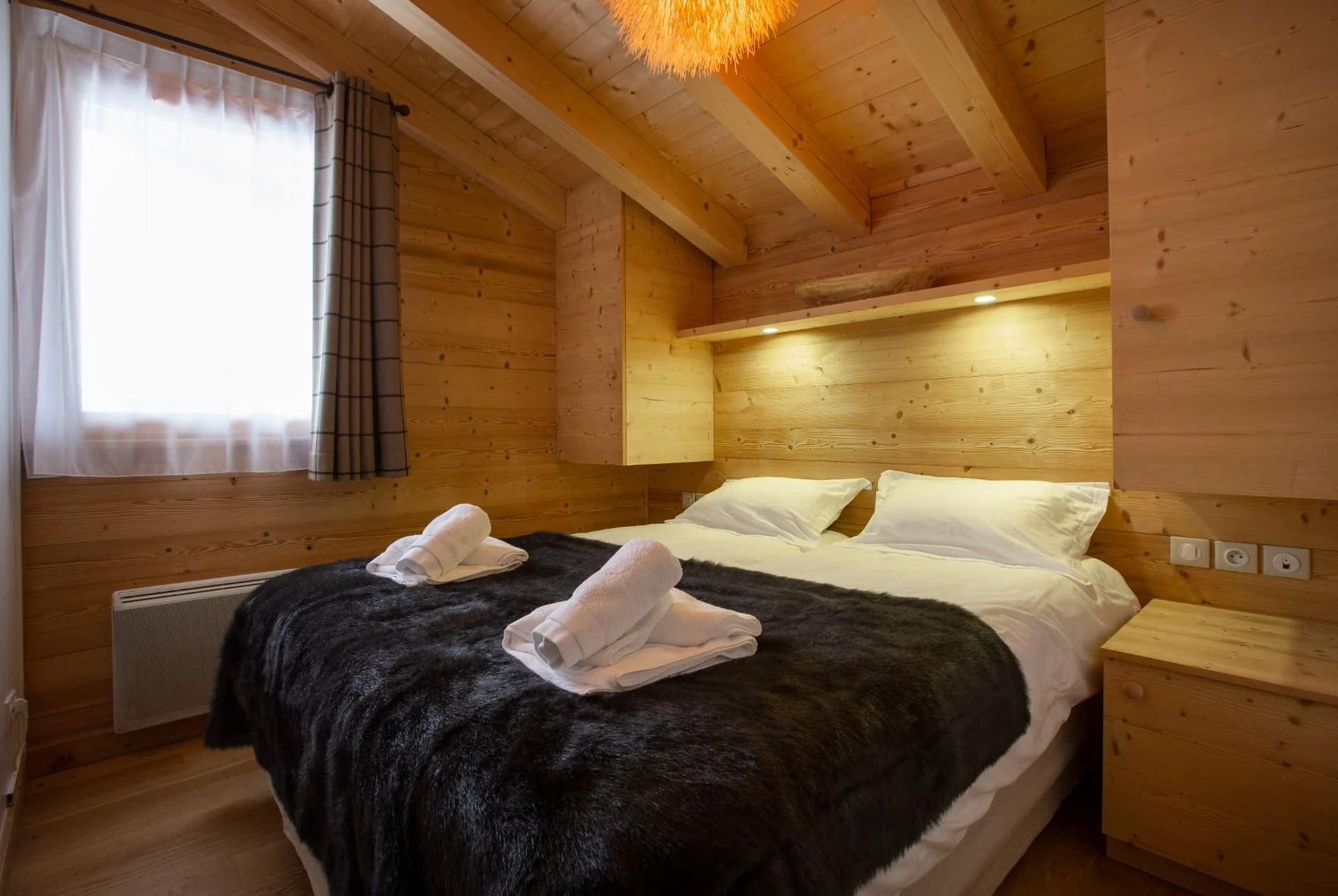 Chambre de l'appartement Belvédère sous rampants avec plaid en fourrure